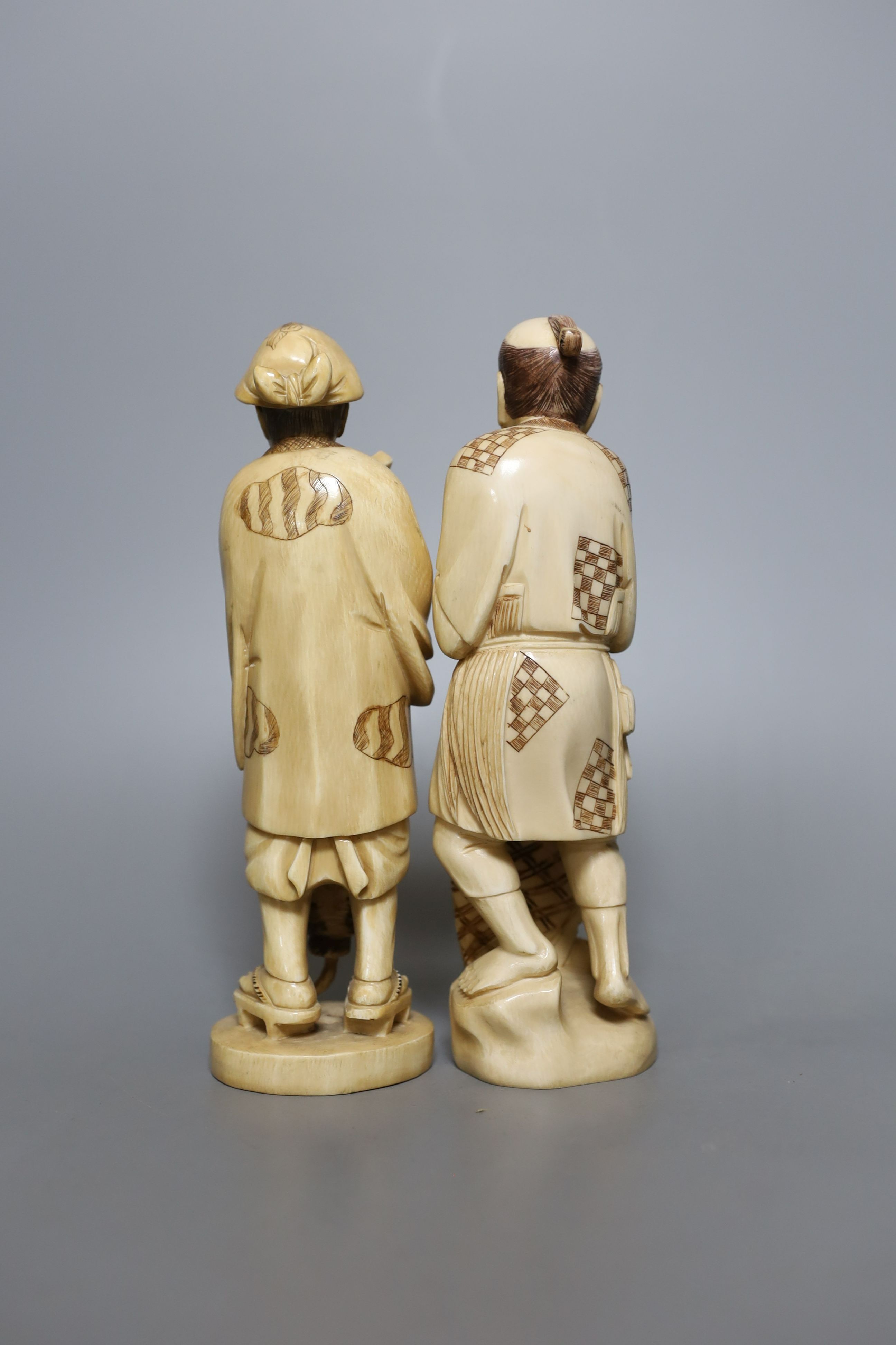 Two Japanese ivory okimono figures of a fisherman and another, marked to base, early 20th century - tallest 21cm